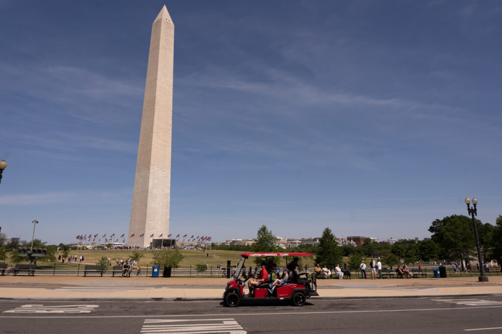 Golf Cart tour on road in front of Washington Monument. Photo taken by Ted Everett