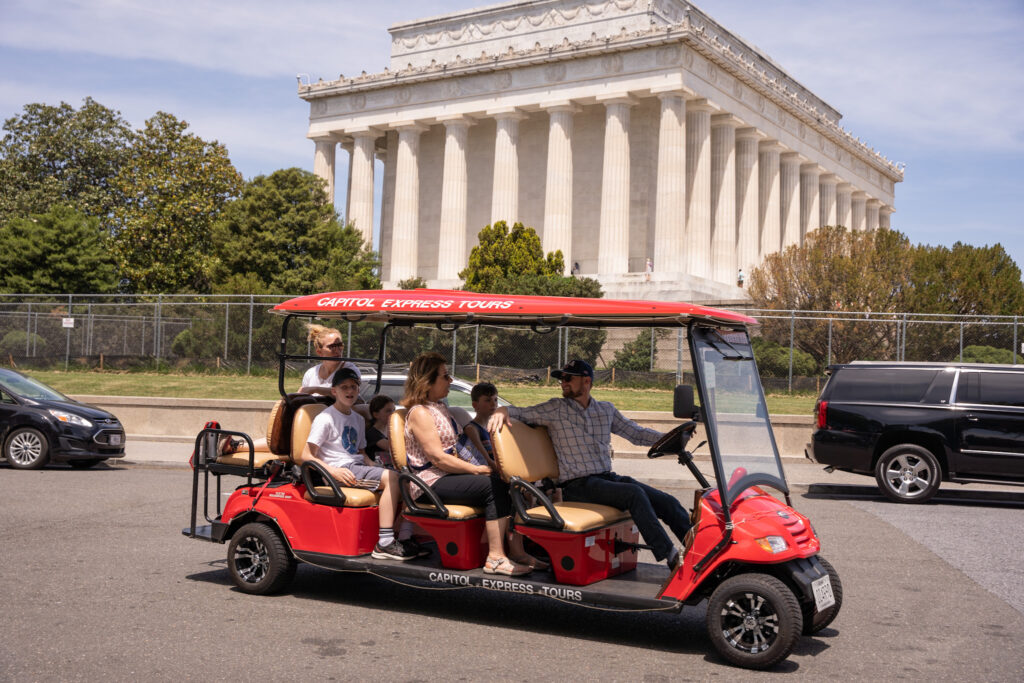 Family in golf cart on tour in front of Lincoln Memorial. Photo taken by Ted Everett